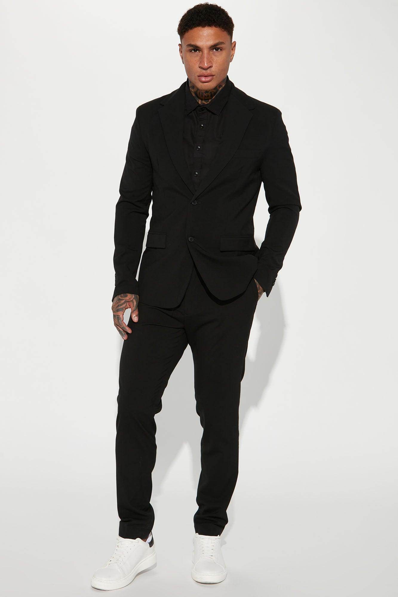 Fashion Nova modern suit jacket for men in black, paired with matching trousers and casual white sneakers