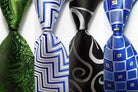 Set of patterned silk neckties in green, silver, black, and blue with various designs for stylish men's accessories