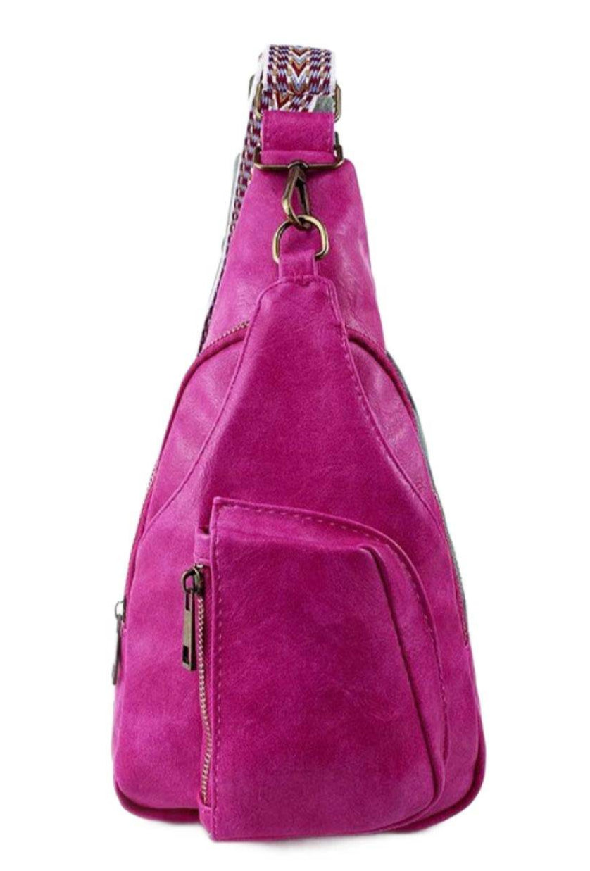 Stylish pink PU leather sling bag with a unique design and convenient side pocket