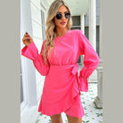 Trendsi Pink Vacation Dress featuring long sleeves and a stylish wrap design