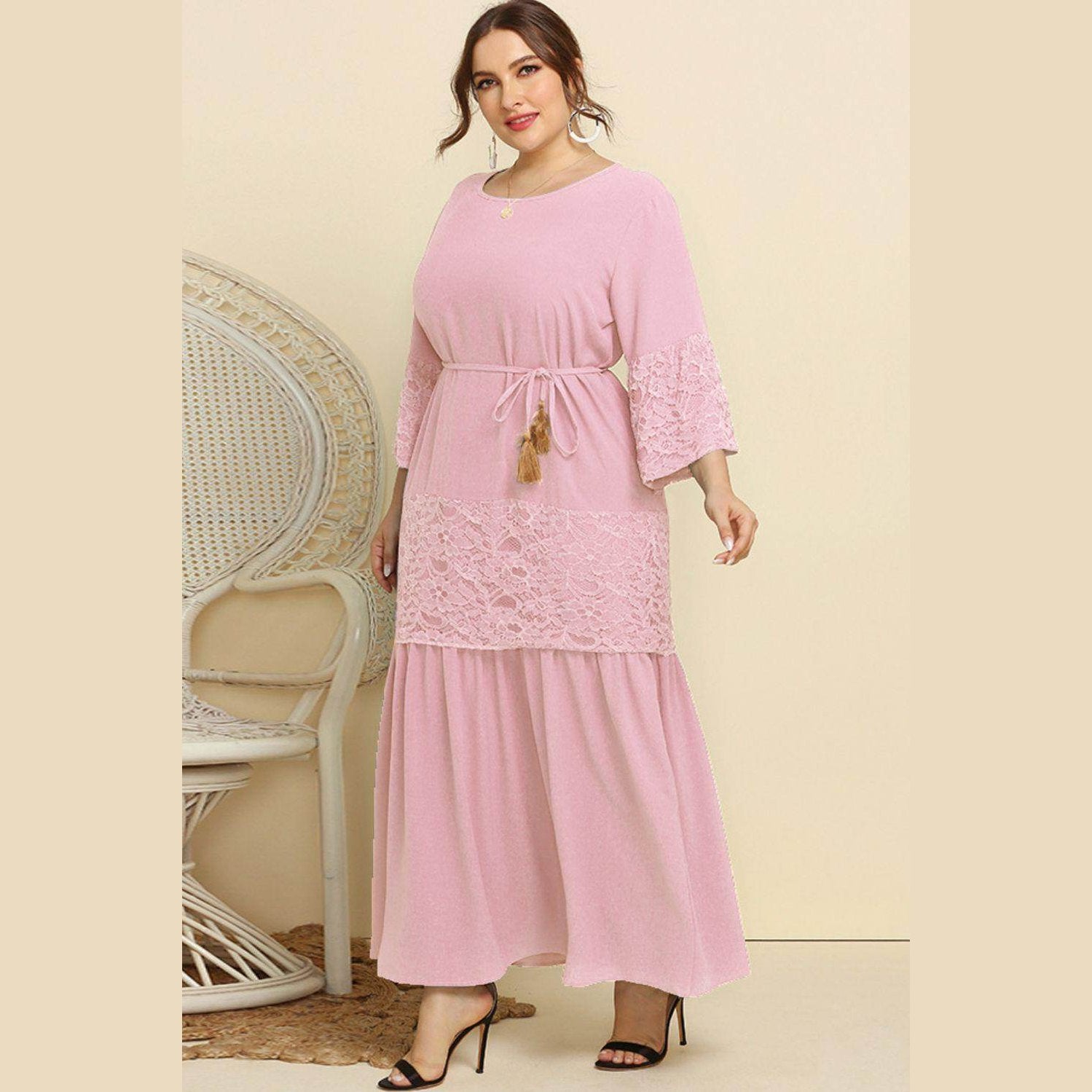Trendsi Plus Size Lace Dress in soft pink with a belted waist and flared sleeves for a stylish look.