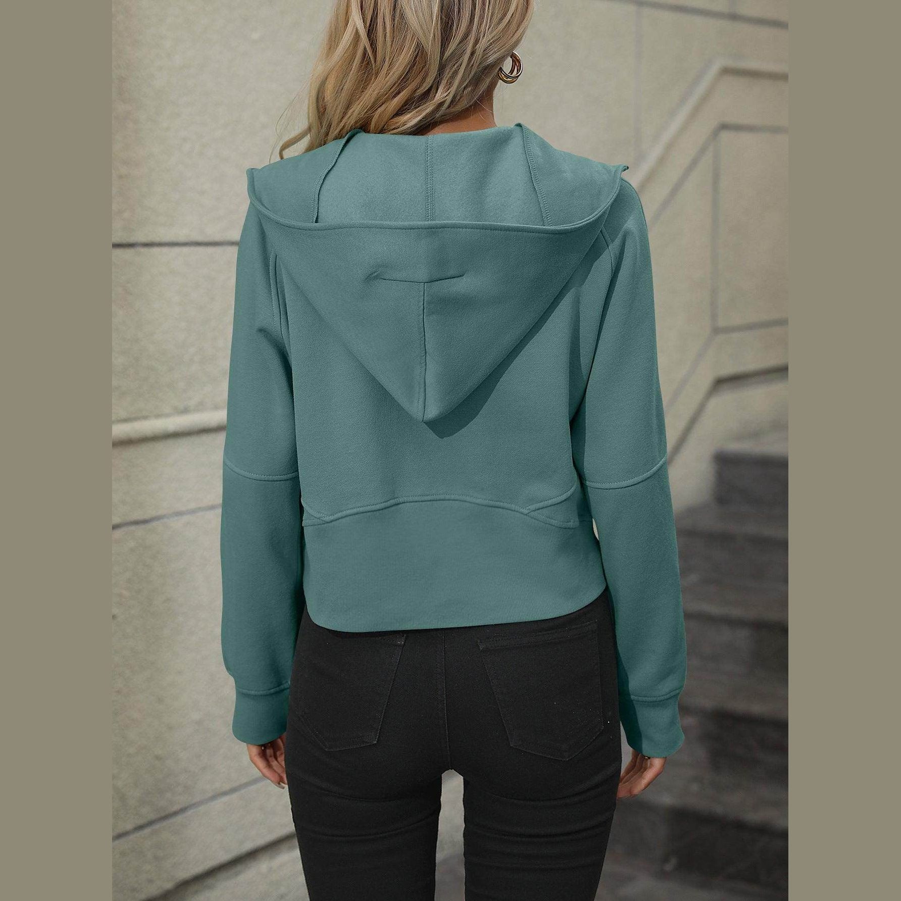 Women's raglan sleeve hoodie in teal with a cropped design and adjustable hood for casual wear