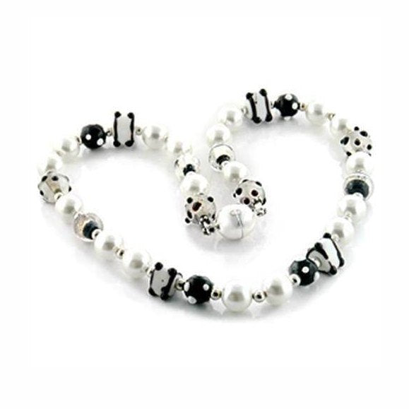 Stylish statement brass and faux pearl necklace featuring black and white beads for a trendy look