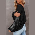 Trendsi stylish vacation blouse featuring a black design with sequin accents and oversized sleeves