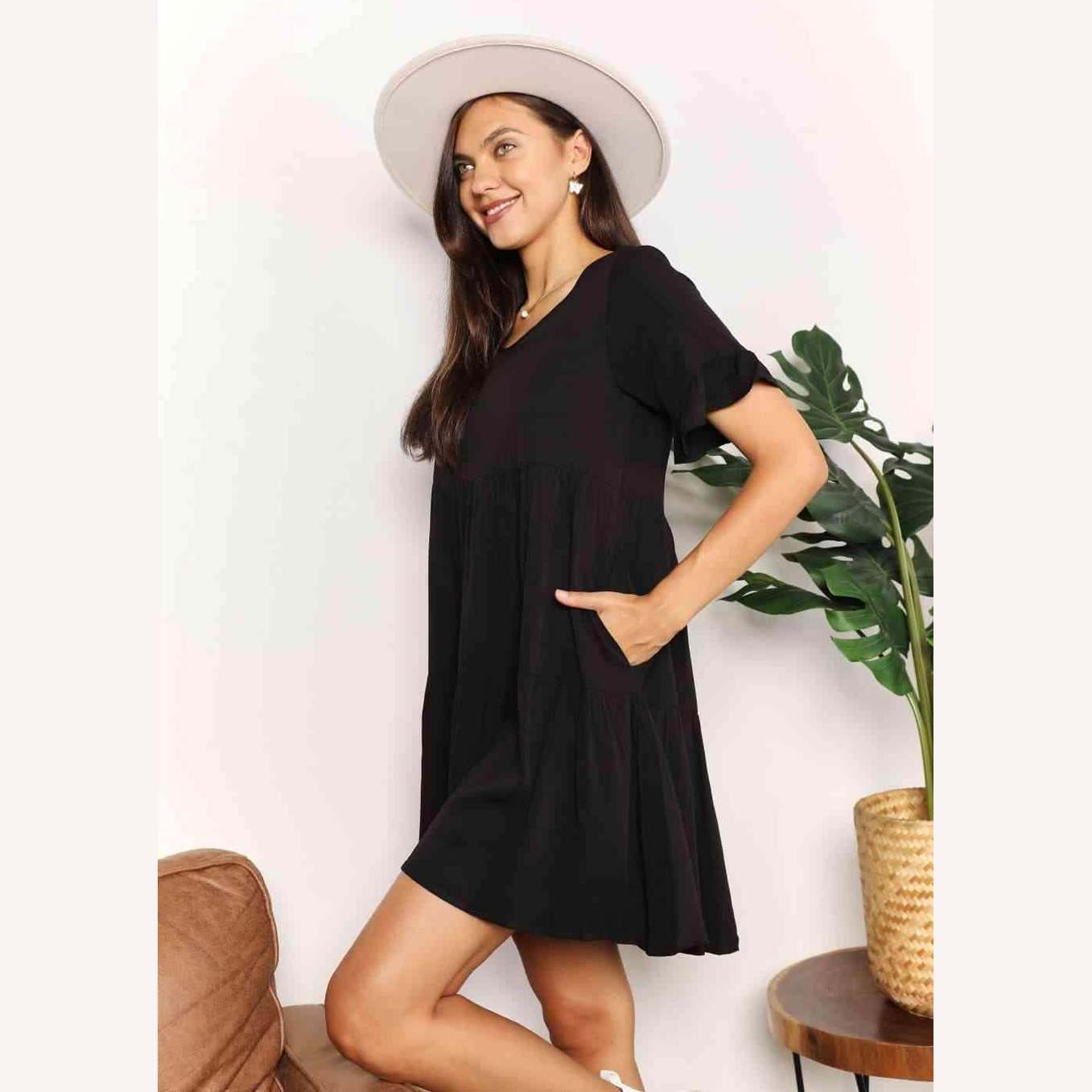 Black tiered summer dress with pockets and short sleeves, perfect for casual outings