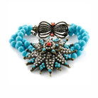 Turquoise and copper statement bracelet featuring intricate design and vibrant colors for a bold look