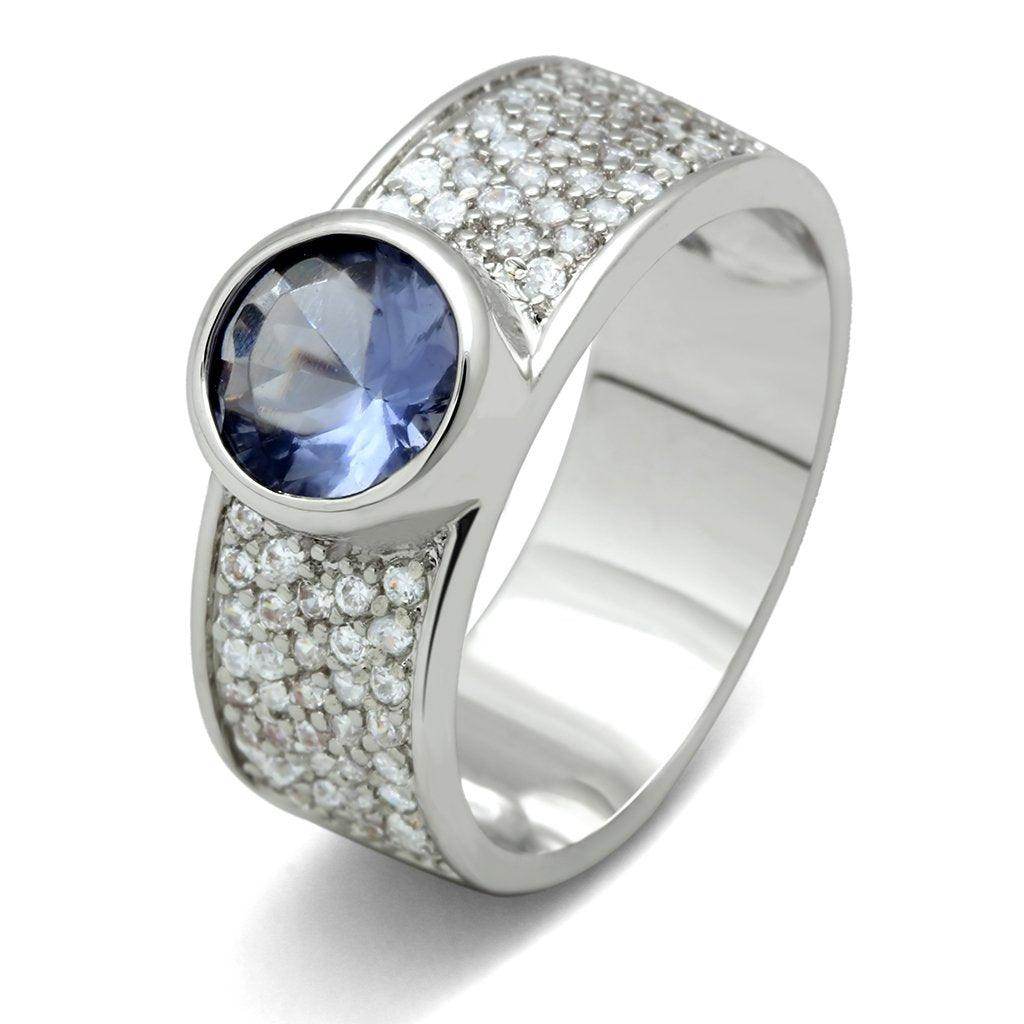 Elegant women's ring featuring a blue gemstone surrounded by sparkling accents, perfect vacation jewelry for women.