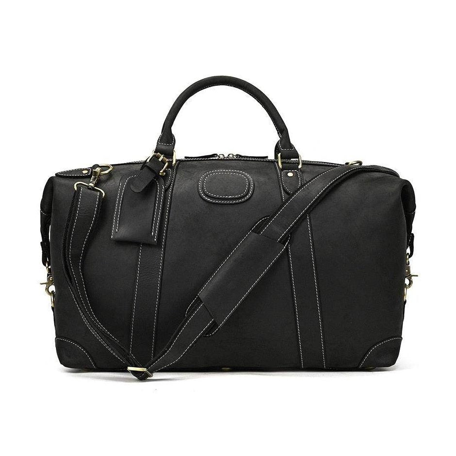 Vacation style leather bag in black with sturdy handles and adjustable shoulder strap