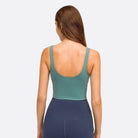 Back view of women's activewear top in teal, perfect for vacation style sportswear