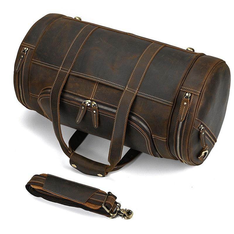 Brown leather weekend travel bag with multiple pockets and a detachable strap for easy carrying