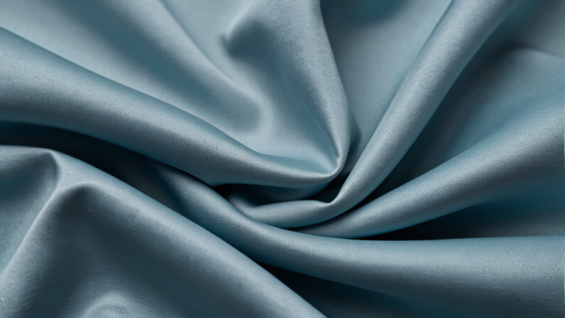 Close-up of Tiffany blue fabric texture with soft folds and elegant sheen