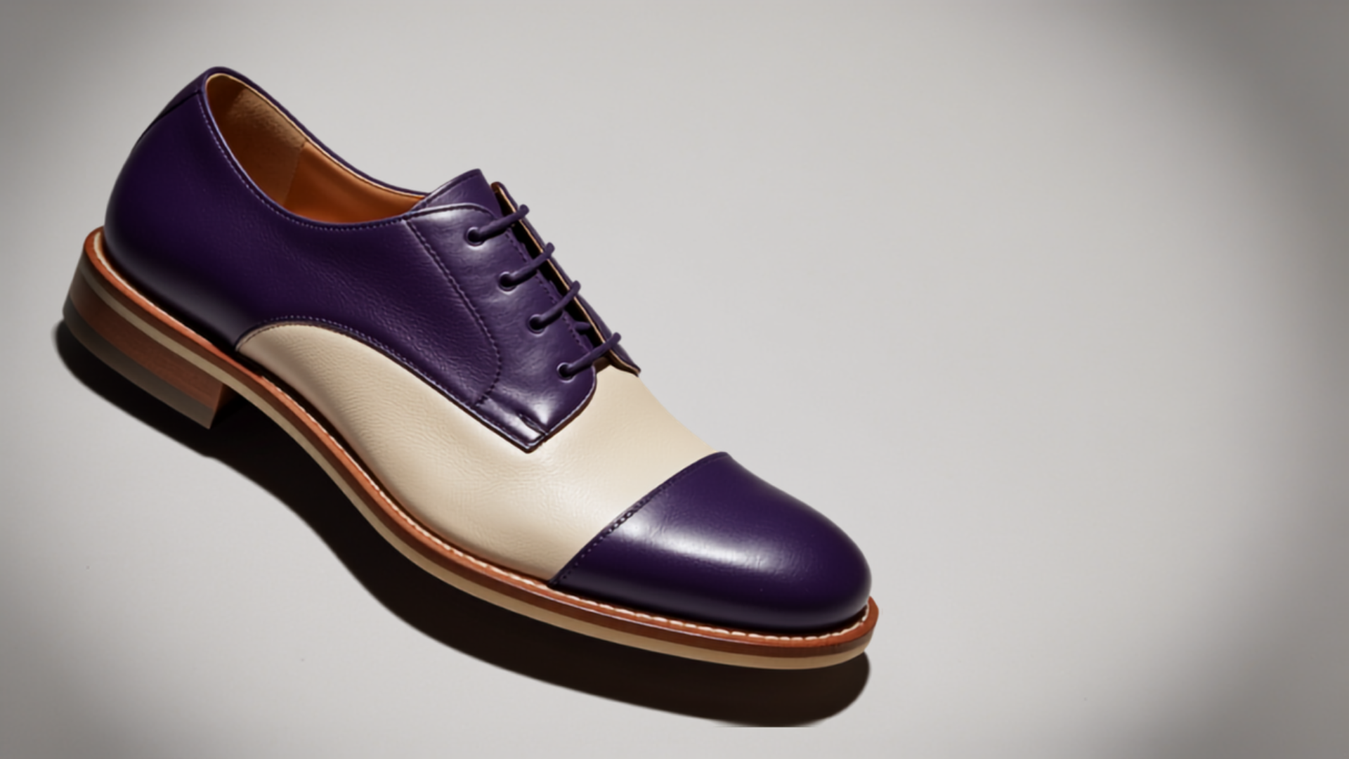 Close-up of two-tone purple and cream shoes arranged diagonally, showing texture detail