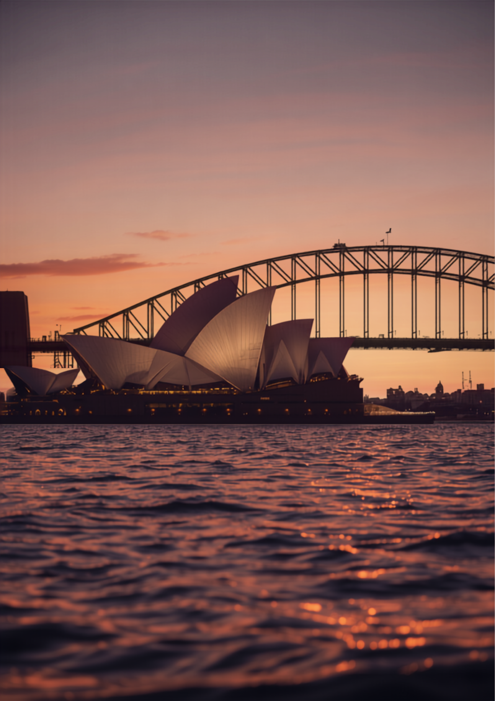 Sydney Opera House and Harbour Bridge at golden hour viewed from the water