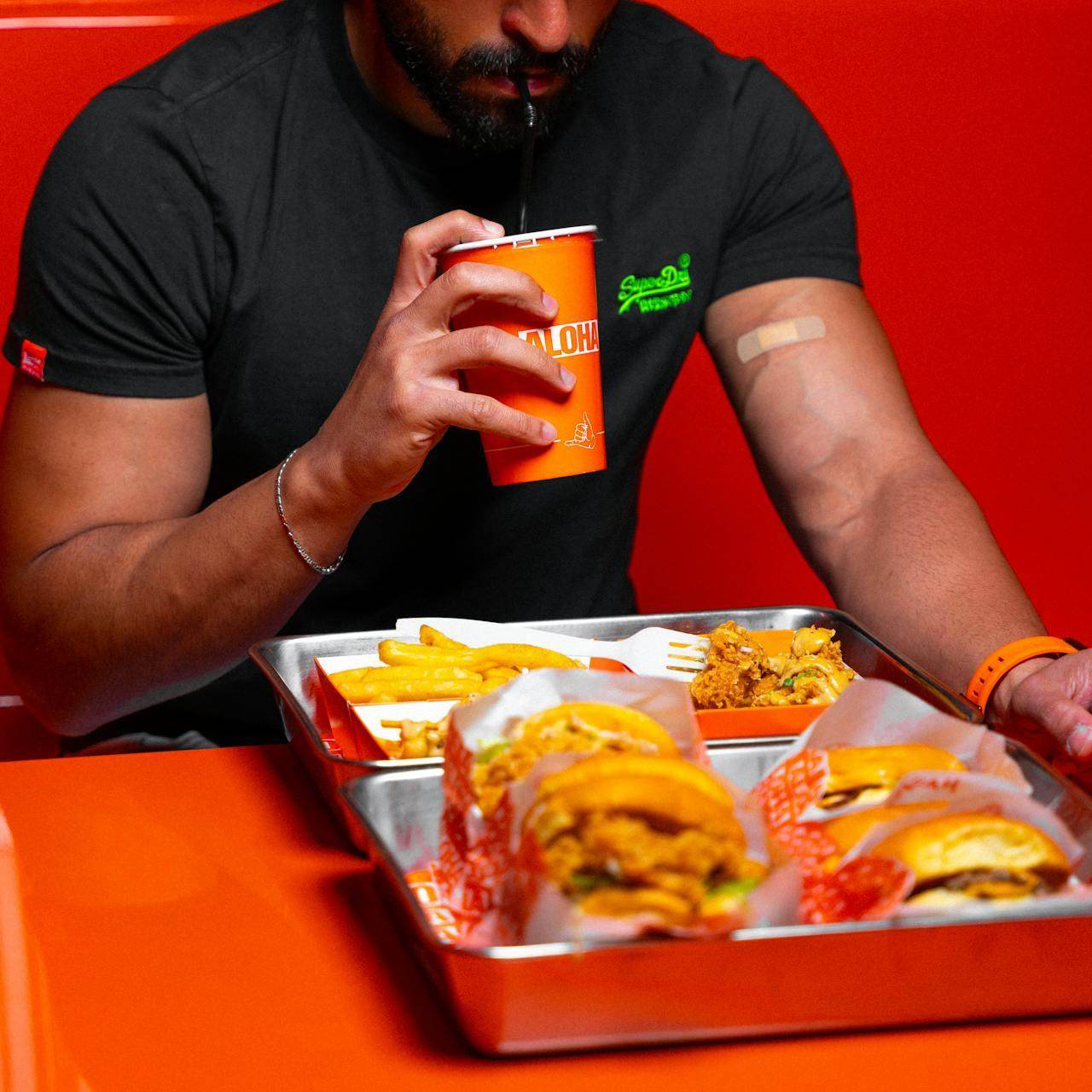 A diner enjoying burgers and fries at an eatery in Orlando drink hotspots