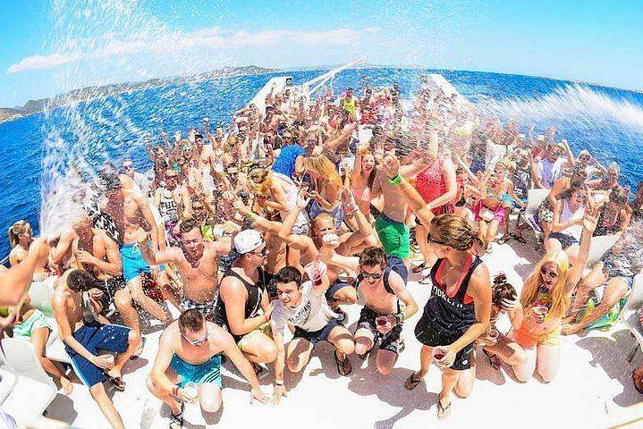 Group of people enjoying a lively boat party during Cancun summer vacation planning