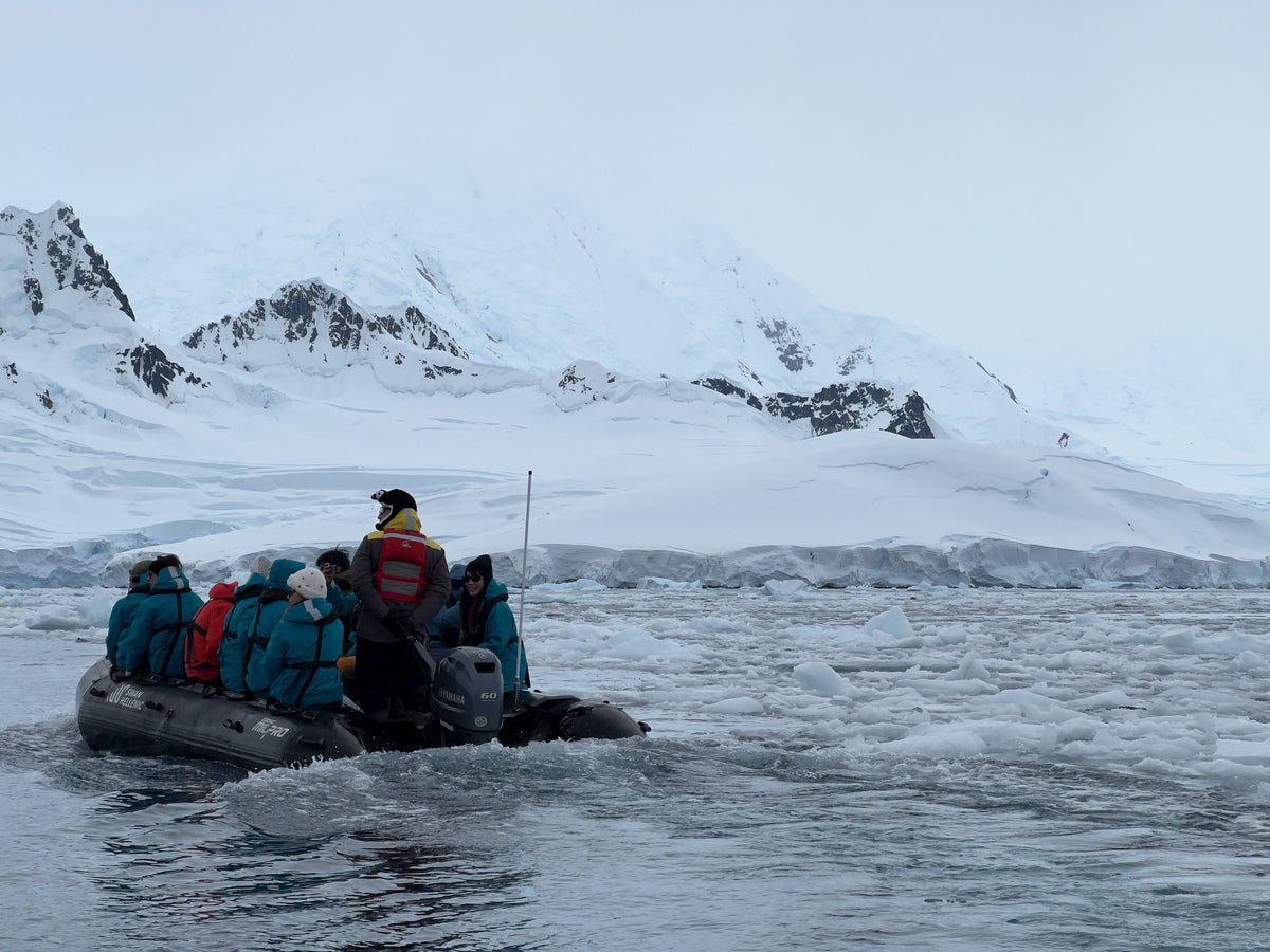Tourists in a Zodiac inflatable boat navigate through brash ice near the Antarctic Peninsula during an expedition cruise landing. Photo: Srishti Sethi, CC BY-SA 4.0, via Wikimedia Commons