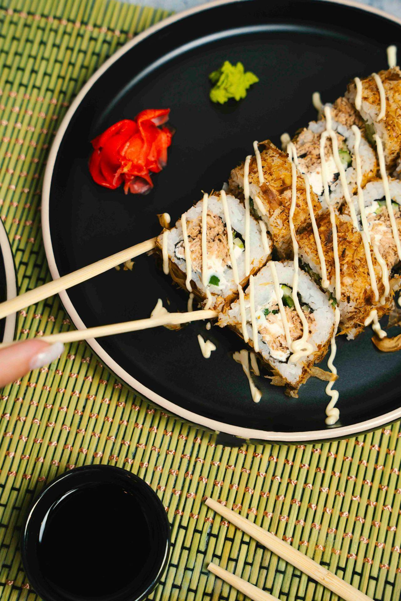 Delicious sushi rolls presented in a street food guide for travelers with dipping sauce and toppings