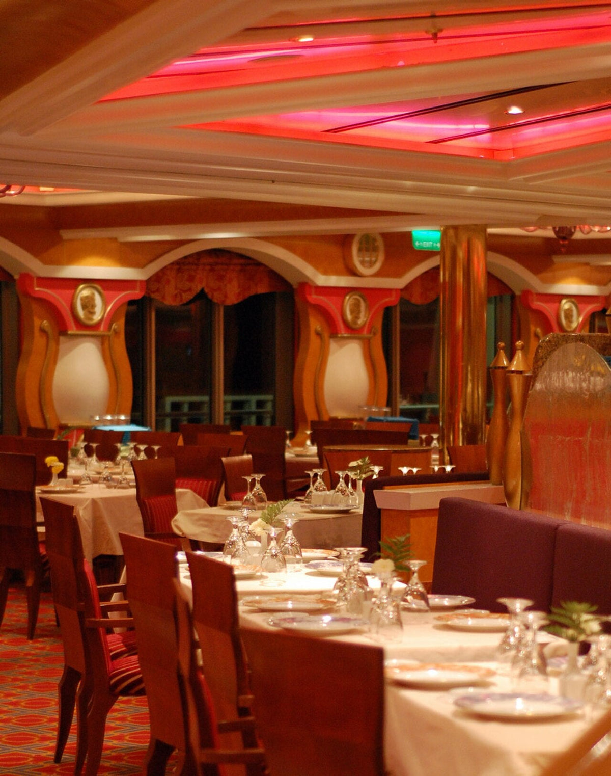 Elegant cruise ship main dining room set for dinner with white tablecloths
