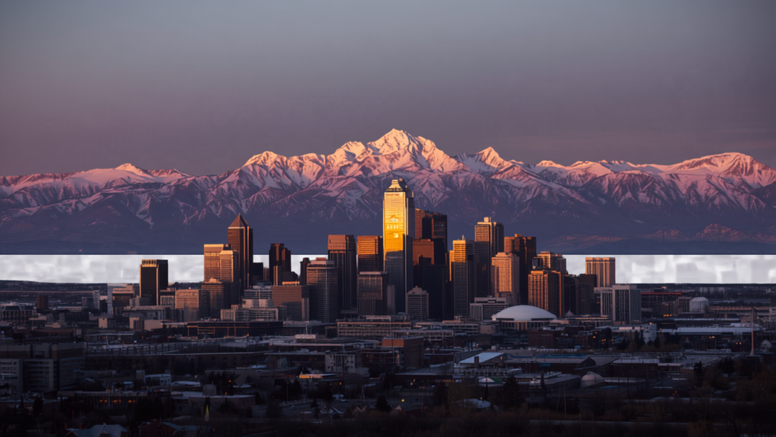 Denver skyline with the Rocky Mountains rising behind it at sunset