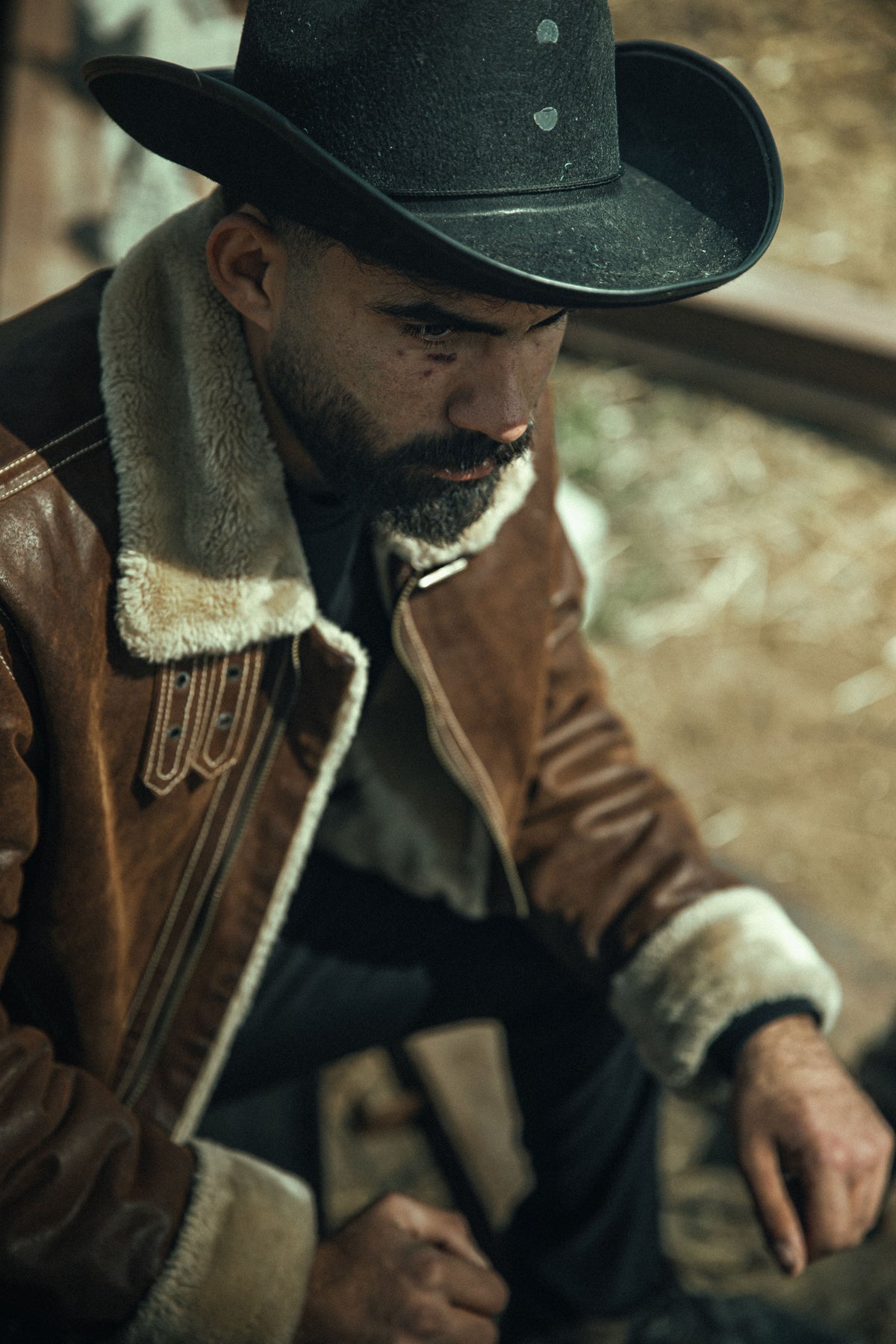 A man wearing a shearling fleece jacket outdoors