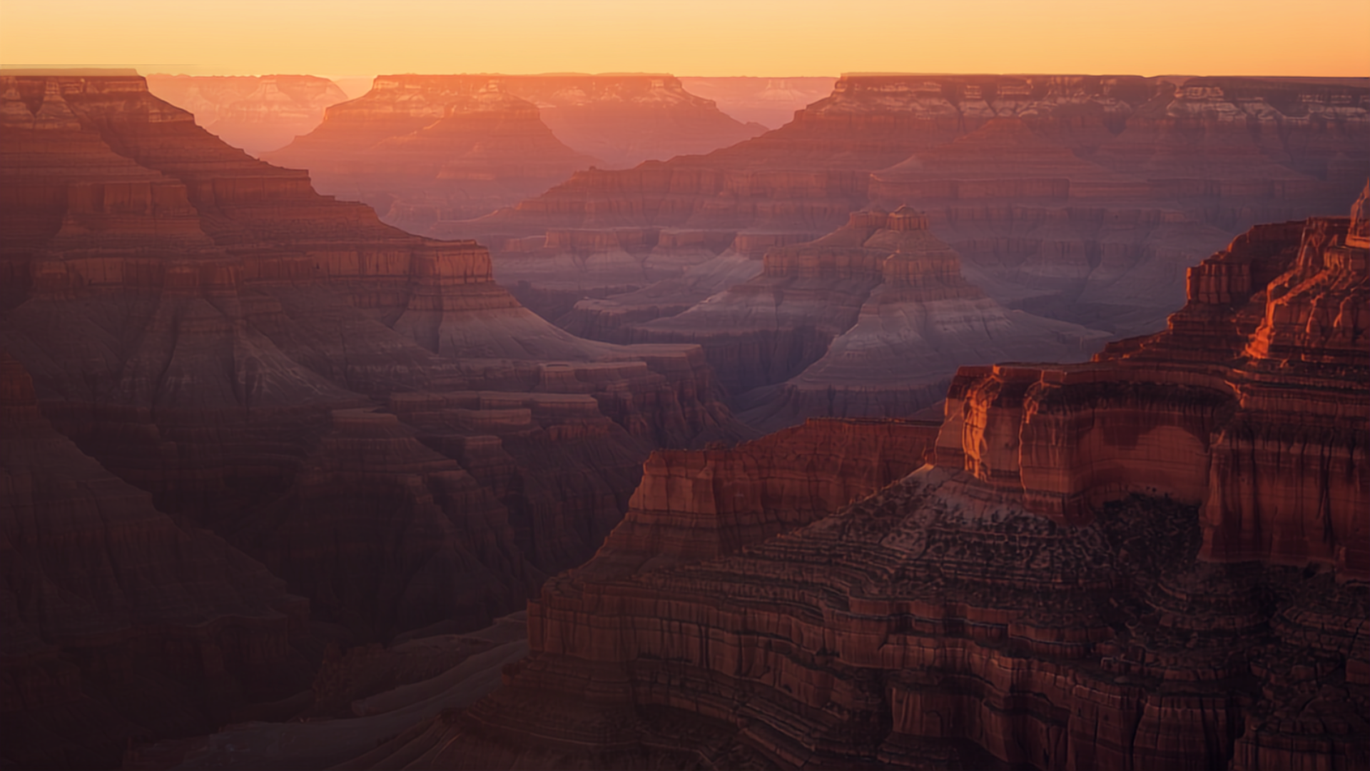 Dramatic layered rock canyon walls at sunset in the Grand Canyon