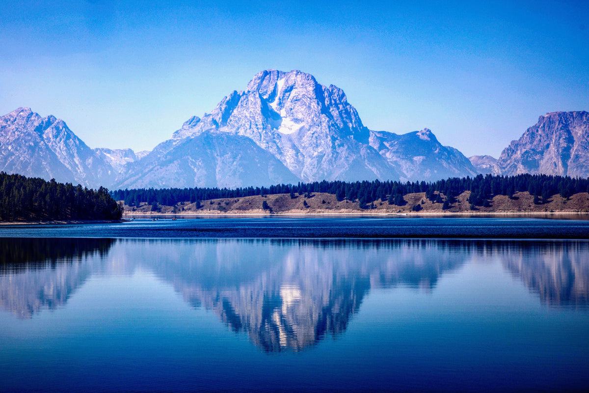 Grand Teton peak reflected in a calm lake near Jackson Hole