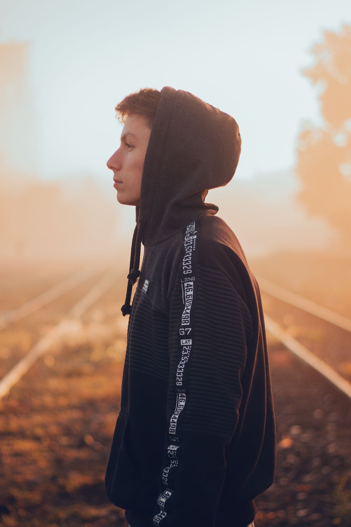 Man wearing a hoodie in golden light