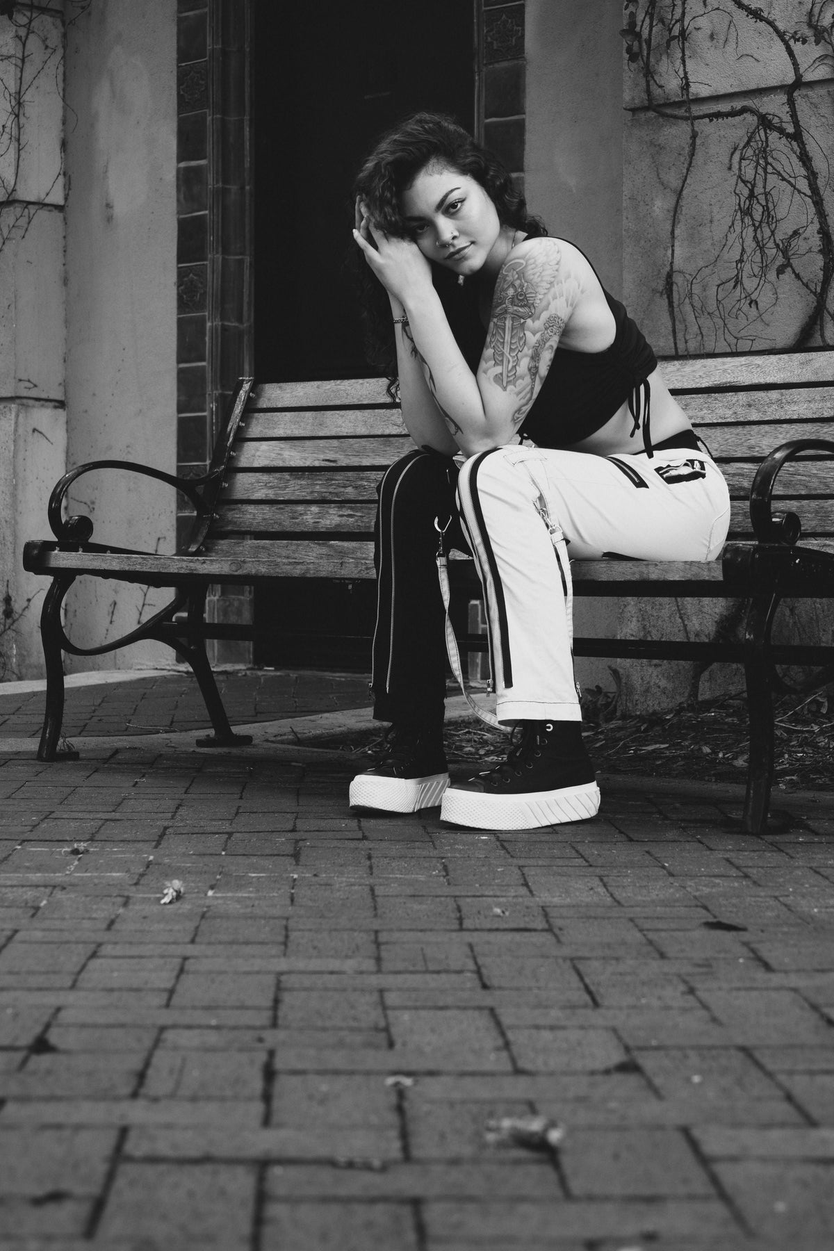 Woman wearing platform sneakers sitting on a bench