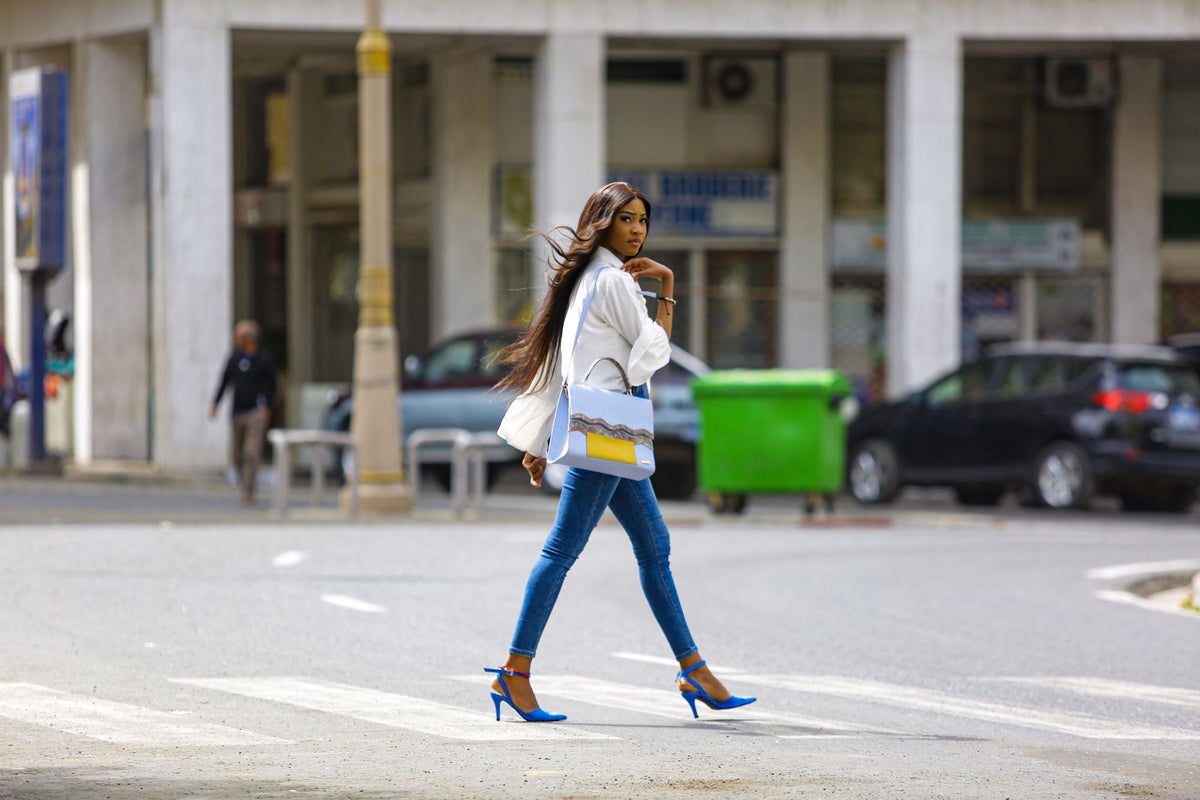 Woman wearing blue heels walking on a city street