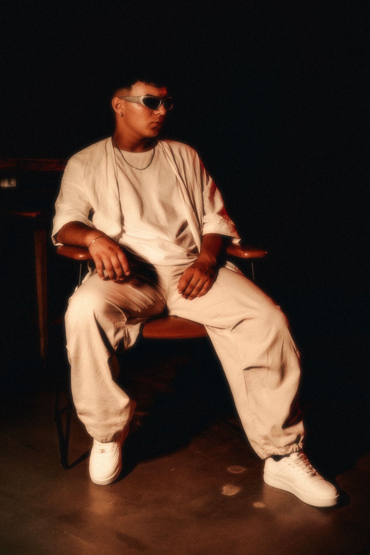 Man wearing cream joggers sitting in armchair