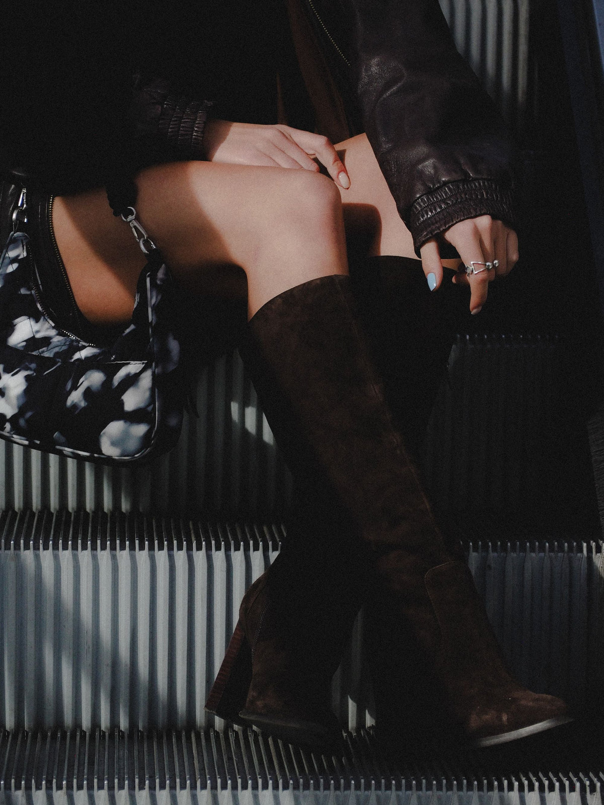 Close up of woman wearing suede knee-high boots