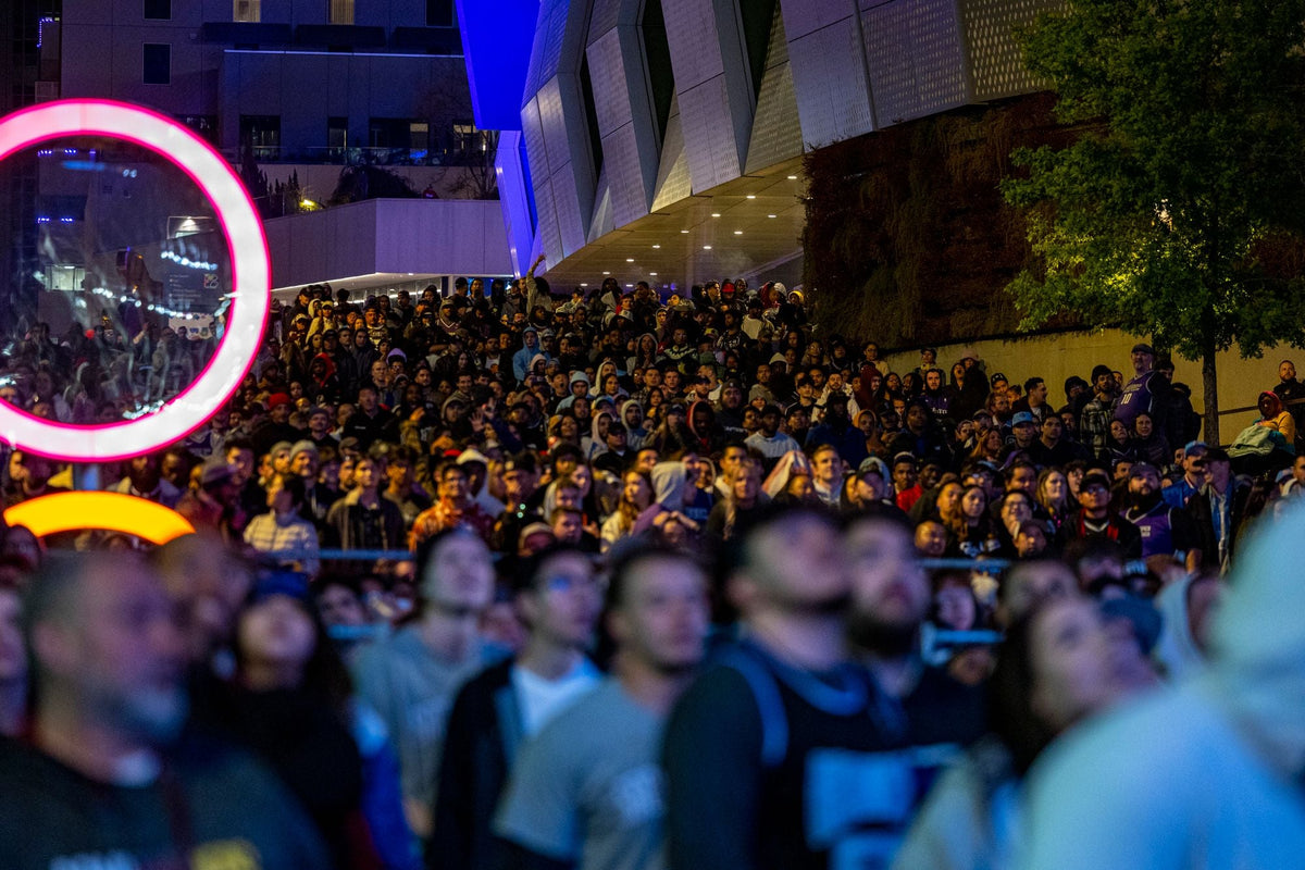 Large costumed crowd at a nighttime Halloween street festival