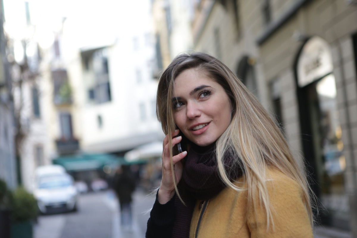 Woman wearing a scarf on a city street in autumn