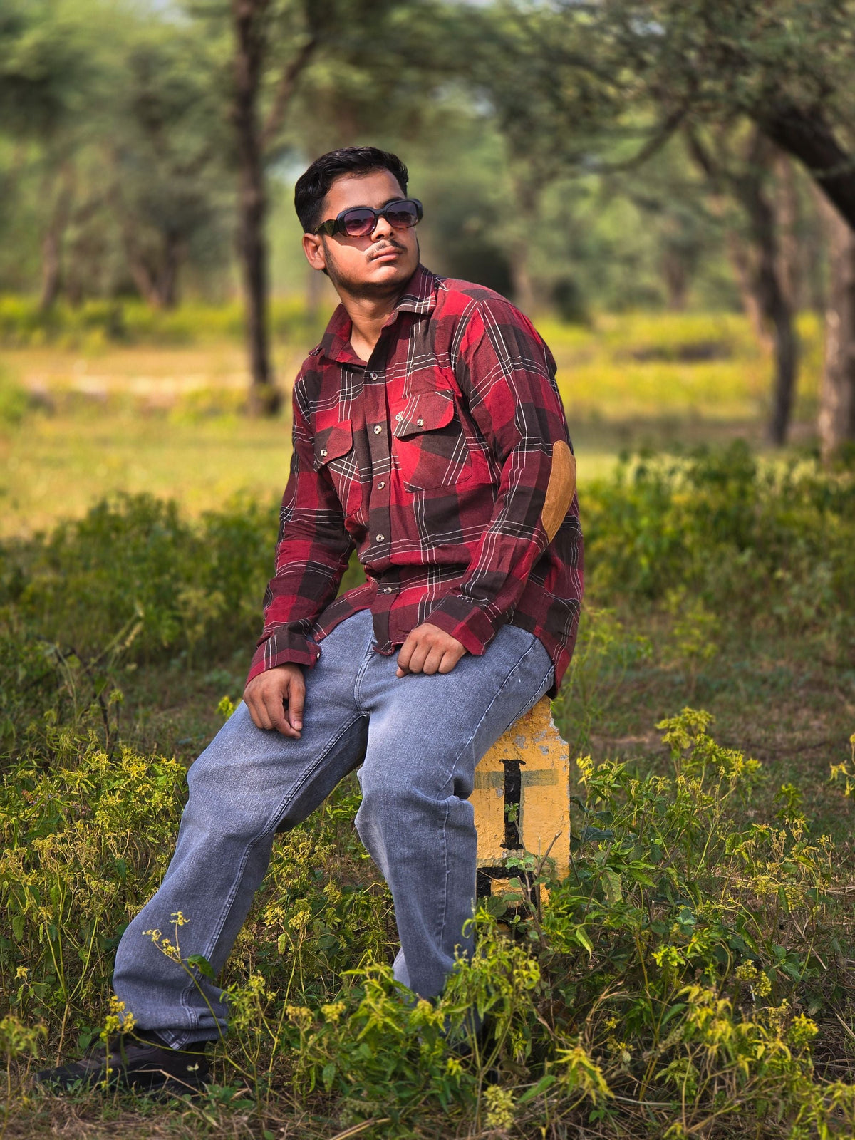 Man wearing a red plaid flannel shirt outdoors