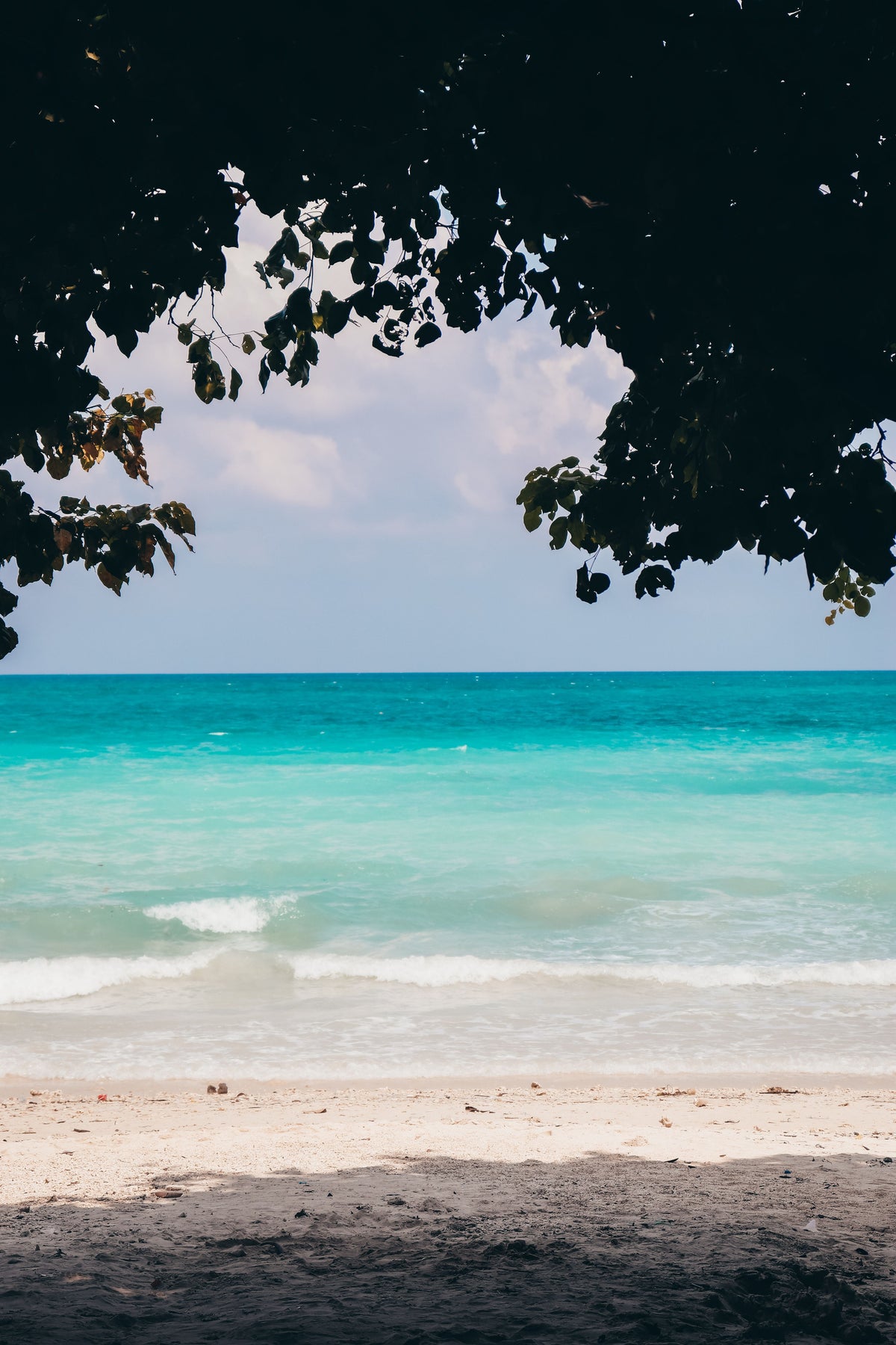 Waves washing up on a quiet tropical sandy beach