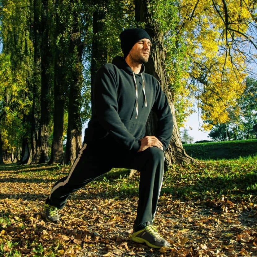 men's activewear for optimal performance. Man stretching in jogging suit before running