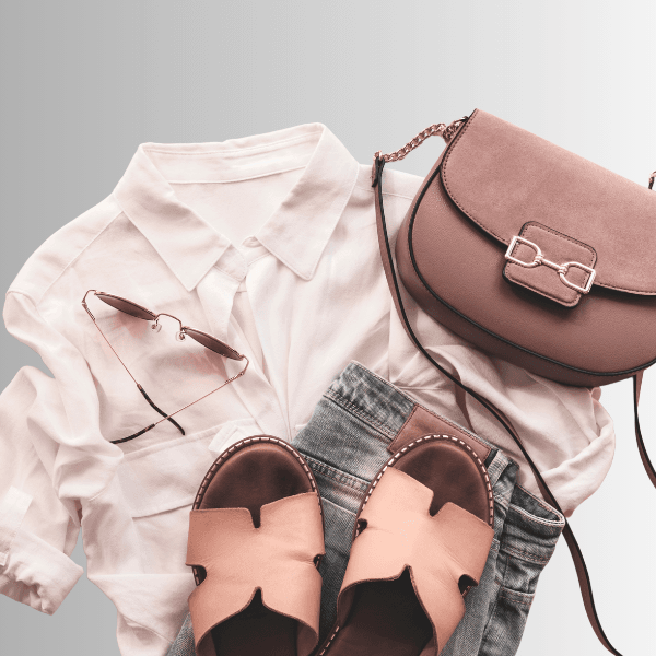 Stylish women's travel clothing featuring a blouse, denim, sandals, and a handbag for your vacation wardrobe
