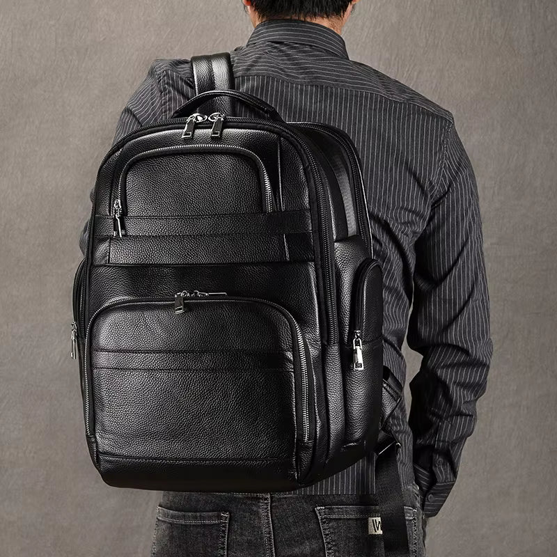 Stylish leather backpacks for daily wear displayed with accessories on a rustic wooden table
