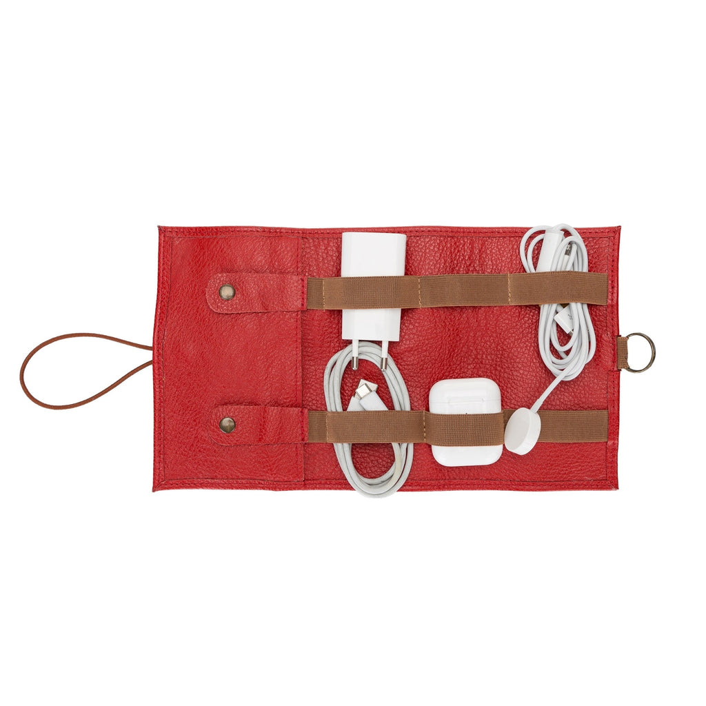 Red organizer with brown straps holding electronic accessories on a white background