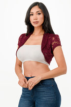 Crochet lace cropped shrug with open front and cap sleeves.