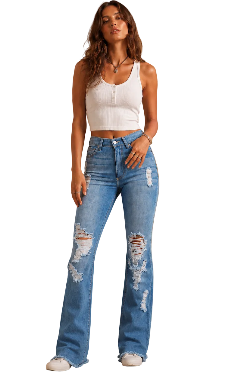 Woman wearing a white crop top and blue distressed jeans against a brown background