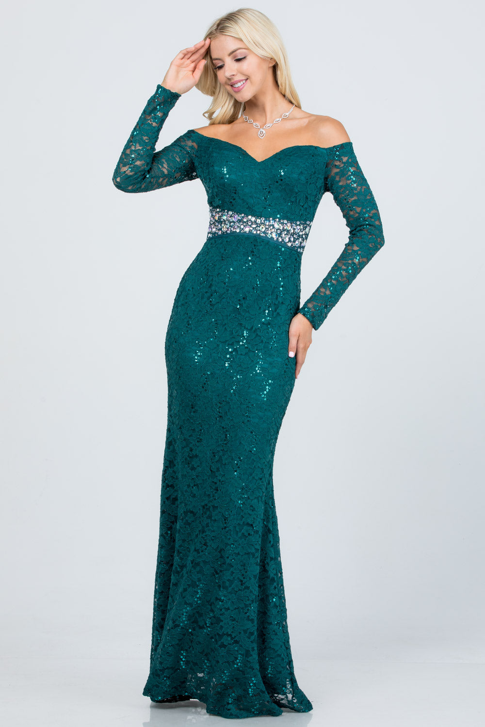 Off the shoulder long sleeve sweetheart sequin lace gown with waist embellishment.