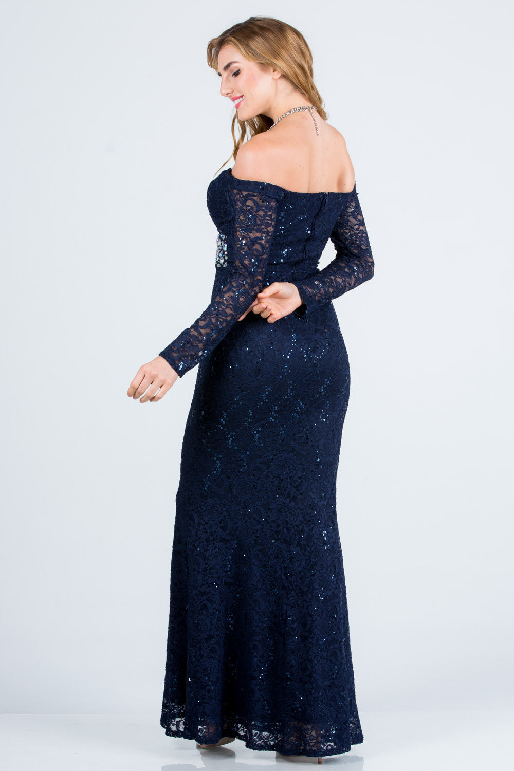 Off the shoulder long sleeve sweetheart sequin lace gown with waist embellishment.