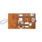 Brown leather case with USB cables and connectors on a white background