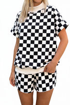 Person wearing a black and white checkered outfit on a street.