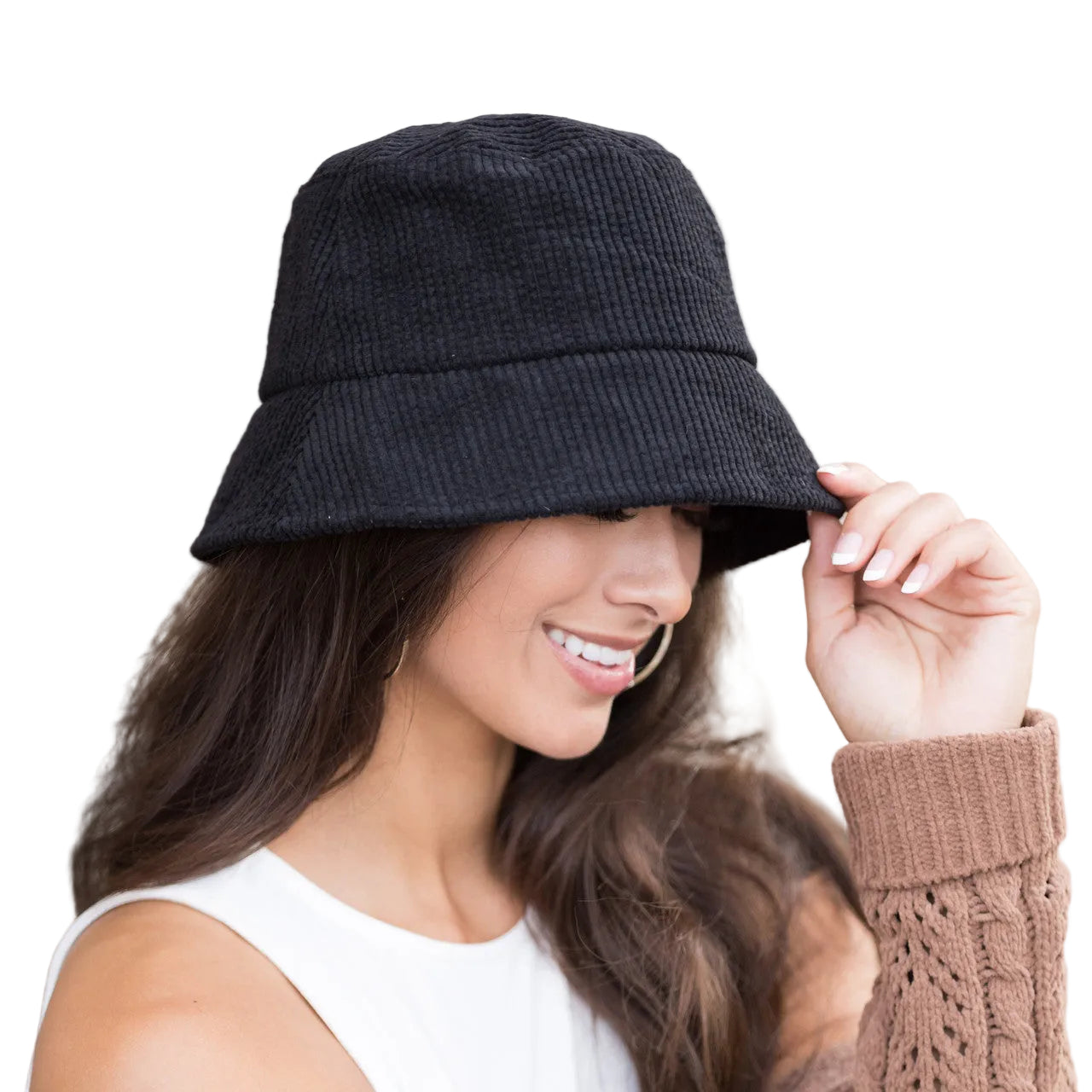 Woman wearing a black bucket hat against a neutral background