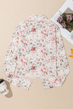 Back view of a JUNIPER BLVD mock neck floral blouse for women with a delicate pink floral pattern