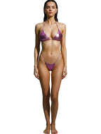 A woman modeling a shiny metallic purple bikini against a solid white background.