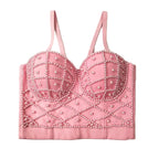 Pink bralette with pearl embellishments on a white background