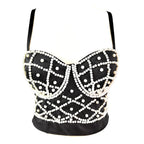 Black leather top with white bead embellishments on a white background